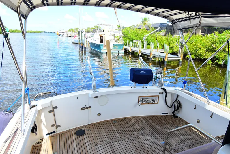  Yacht Photos Pics 1994 Grand Banks 38 Eastbay yacht with teak deck, docked in a serene marina.