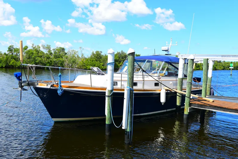  Yacht Photos Pics 1994 Grand Banks 38 Eastbay yacht docked by a serene waterfront.