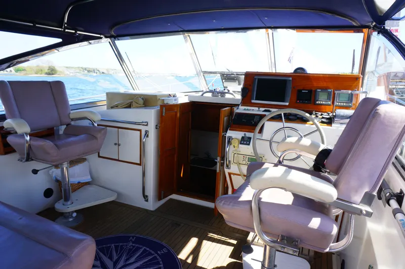  Yacht Photos Pics Interior of 1994 Grand Banks 38 Eastbay yacht with helm, seating, and navigation equipment.