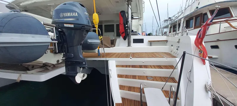 Amea Yacht Photos Pics Lagoon 52 F 2014 yacht with Yamaha outboard motor, docked at marina.