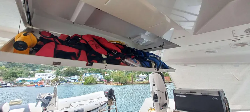 Amea Yacht Photos Pics Storage compartment on a 2014 Lagoon 52 F yacht, containing life jackets and equipment.