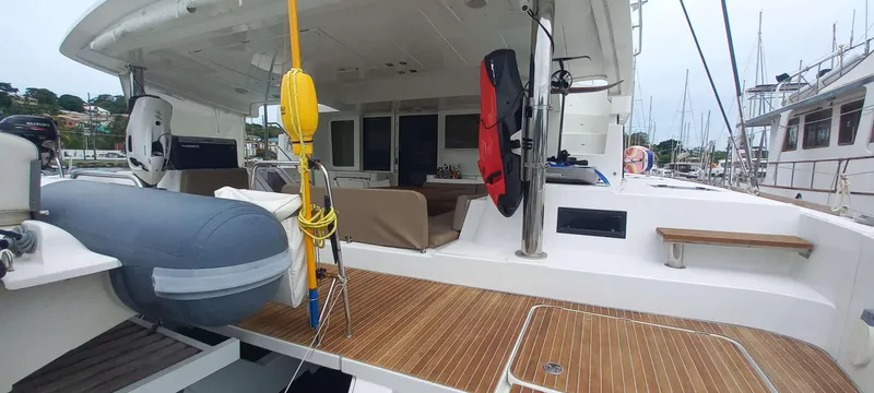 Amea Yacht Photos Pics 2014 Lagoon 52 F yacht deck with seating, dinghy, and marina view.
