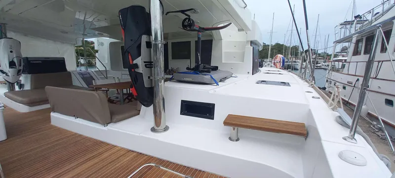 Amea Yacht Photos Pics 2014 Lagoon 52 F yacht deck with seating and equipment, docked at a marina.