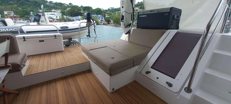 Amea Yacht Photos Pics Lagoon 52 F 2014 yacht deck with seating, wooden flooring, and scenic waterfront view.