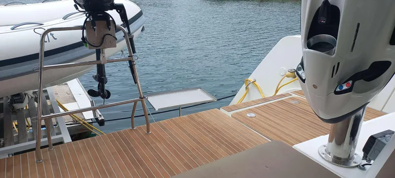 Amea Yacht Photos Pics Lagoon 52 F 2014 yacht deck with tender and outboard motor by the water.