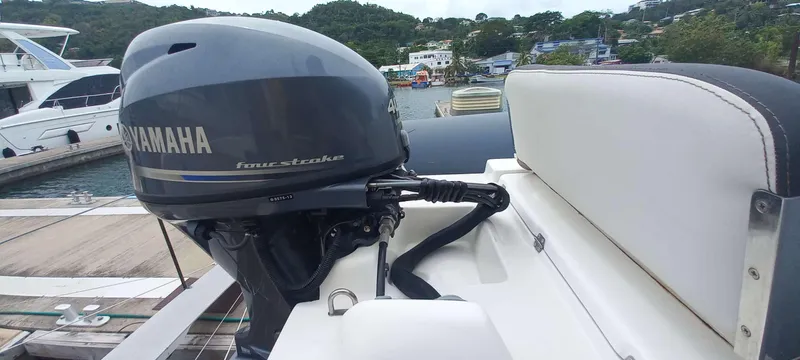Amea Yacht Photos Pics Yamaha four-stroke engine on a 2014 Lagoon 52 F yacht, docked at a marina.
