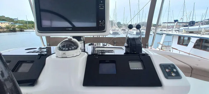 Amea Yacht Photos Pics Helm of 2014 Lagoon 52 F yacht with navigation equipment and marina view.