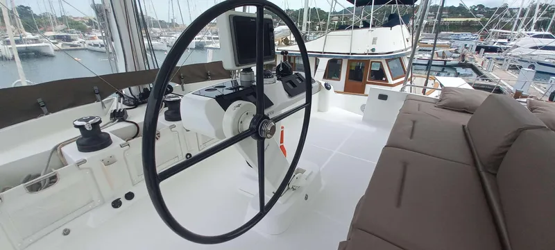Amea Yacht Photos Pics Helm of 2014 Lagoon 52 F catamaran with modern navigation equipment, docked at marina.