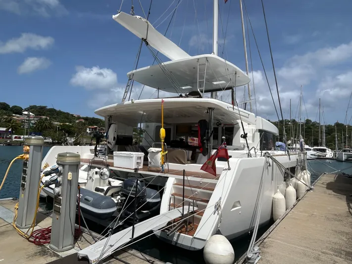 Amea Yacht Photos Pics 2014 Lagoon 52 F catamaran docked at marina, featuring spacious deck and modern design.
