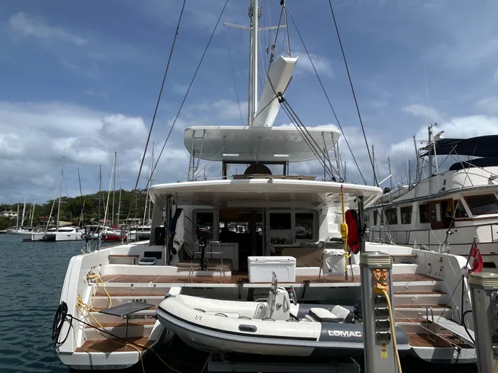 Amea Yacht Photos Pics 2014 Lagoon 52 F catamaran docked at marina, featuring spacious deck and tender boat.