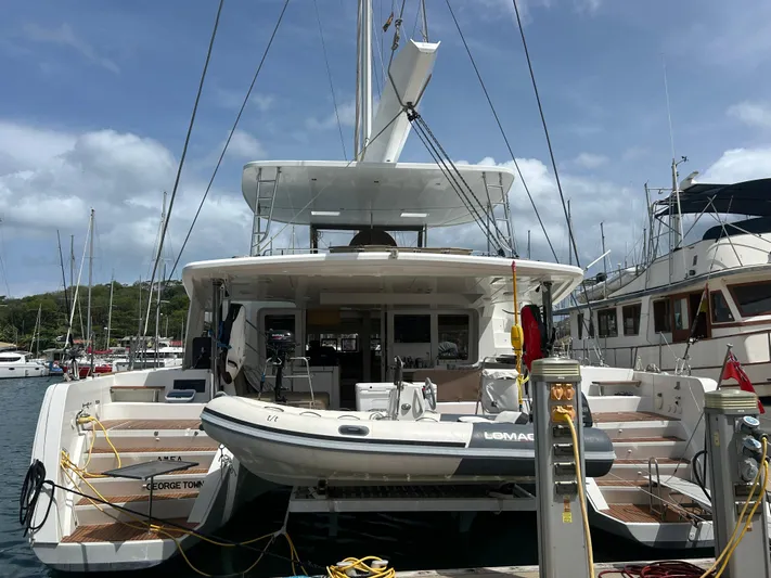 Amea Yacht Photos Pics 2014 Lagoon 52 F yacht docked at marina with inflatable boat.