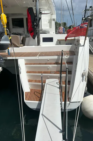 Amea Yacht Photos Pics Lagoon 52 F 2014 yacht with wooden steps and docked at marina.