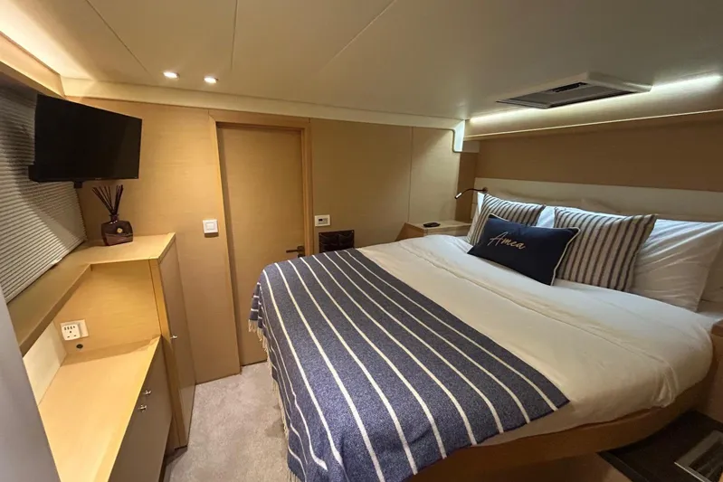 Amea Yacht Photos Pics Luxurious cabin interior of 2014 Lagoon 52 F yacht with cozy bed and modern amenities.