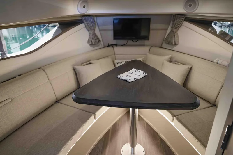  Yacht Photos Pics Interior of 2023 Sea Ray Sundancer 320 Coupe, featuring a cozy seating area and table.