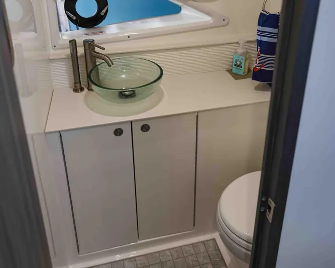  Yacht Photos Pics 2023 Sea Ray Sundancer 320 Coupe bathroom with modern glass sink and compact design.