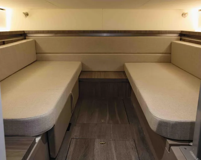  Yacht Photos Pics 2023 Sea Ray Sundancer 320 Coupe cabin interior with beige seating and wooden flooring.