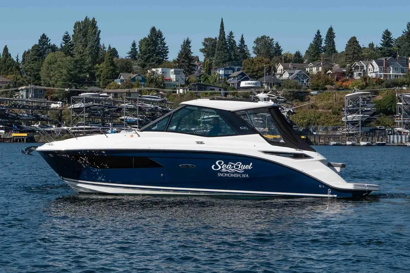  Yacht Photos Pics 2023 Sea Ray Sundancer 320 Coupe cruising on a scenic lake with waterfront homes.
