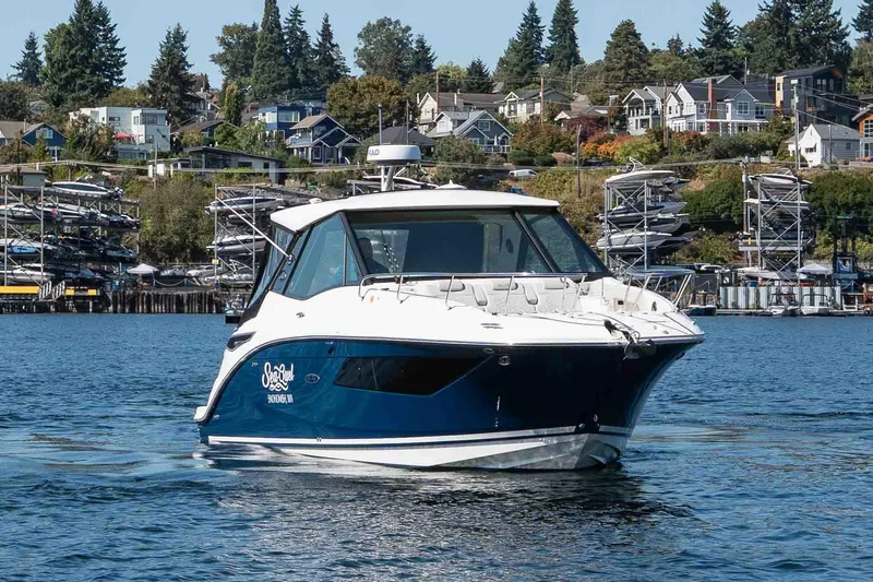  Yacht Photos Pics 2023 Sea Ray Sundancer 320 Coupe cruising on a scenic waterfront.