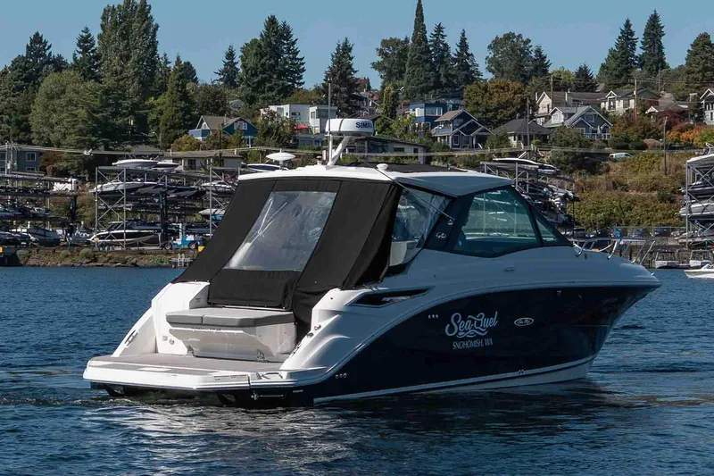  Yacht Photos Pics 2023 Sea Ray Sundancer 320 Coupe cruising on a scenic lake with waterfront homes.