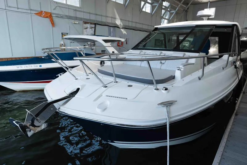  Yacht Photos Pics 2023 Sea Ray Sundancer 320 Coupe docked in a marina, showcasing sleek design.
