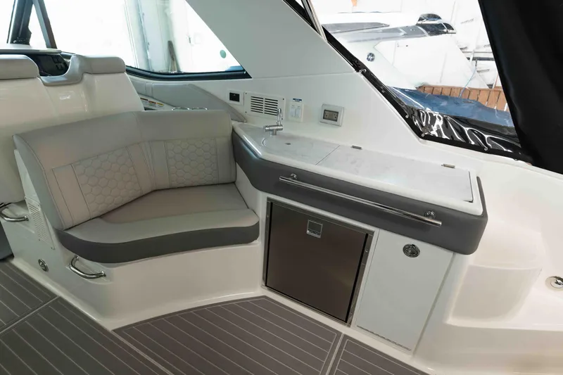  Yacht Photos Pics Interior of 2023 Sea Ray Sundancer 320 Coupe with seating and kitchenette area.