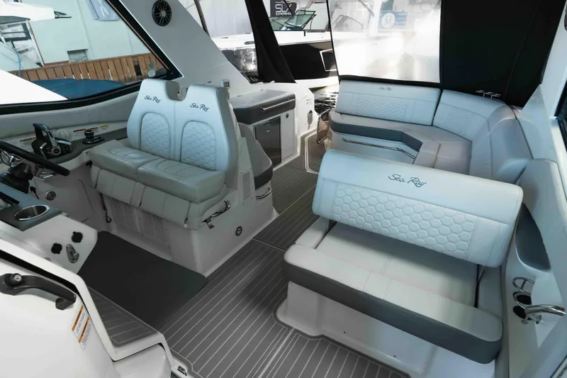  Yacht Photos Pics 2023 Sea Ray Sundancer 320 Coupe interior with luxurious seating and modern helm.