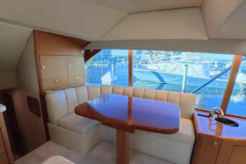 Never Been Fished Yacht Photos Pics Luxurious interior of 2002 Ocean Yachts 52 SS with marina view through large windows.