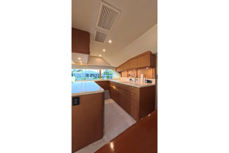 Never Been Fished Yacht Photos Pics Interior of 2002 Ocean Yachts 52 SS, featuring a modern kitchen with wooden cabinetry.