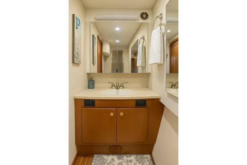 Never Been Fished Yacht Photos Pics Luxurious bathroom in 2002 Ocean Yachts 52 SS, featuring elegant fixtures and wood cabinetry.