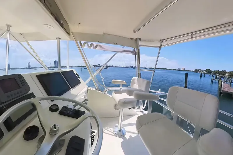 Never Been Fished Yacht Photos Pics 2002 Ocean Yachts 52 SS helm with panoramic water view, featuring modern navigation equipment.