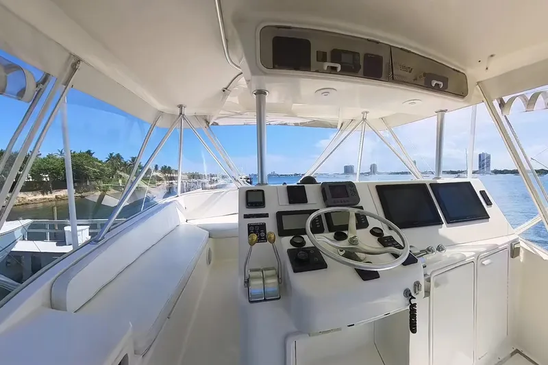 Never Been Fished Yacht Photos Pics Cockpit view of 2002 Ocean Yachts 52 SS, featuring navigation controls and ocean backdrop.
