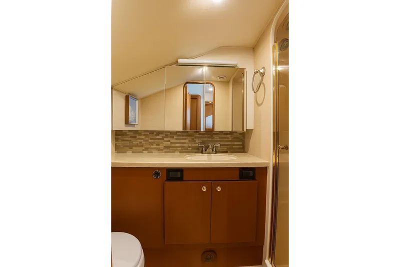 Never Been Fished Yacht Photos Pics Luxurious bathroom in 2002 Ocean Yachts 52 SS, featuring modern fixtures and elegant design.