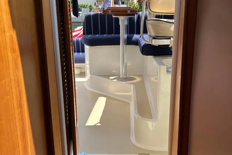  Yacht Photos Pics 2005 Hunt Yachts Surfhunter 33 interior with blue seating and wooden accents.