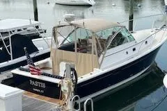  Yacht Photos Pics 2005 Hunt Yachts Surfhunter 33 docked, featuring a sleek design and American flag.