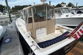  Yacht Photos Pics 2005 Hunt Yachts Surfhunter 33 docked, featuring a spacious deck and American flag.