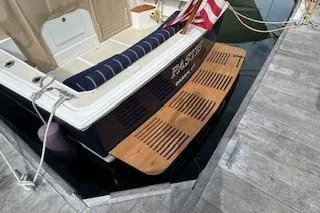  Yacht Photos Pics 2005 Hunt Yachts Surfhunter 33 docked with American flag and wooden swim platform.