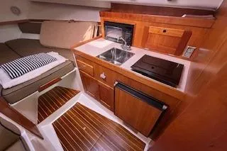  Yacht Photos Pics 2005 Hunt Yachts Surfhunter 33 interior with kitchenette and cozy seating area.
