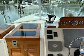  Yacht Photos Pics 2005 Hunt Yachts Surfhunter 33 helm with wooden cabinetry and navigational controls.