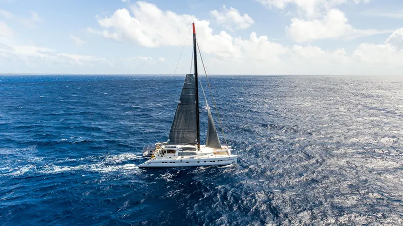 Orion Yacht Photos Pics Catana 90 catamaran sailing on open ocean under clear skies, 2008 model.