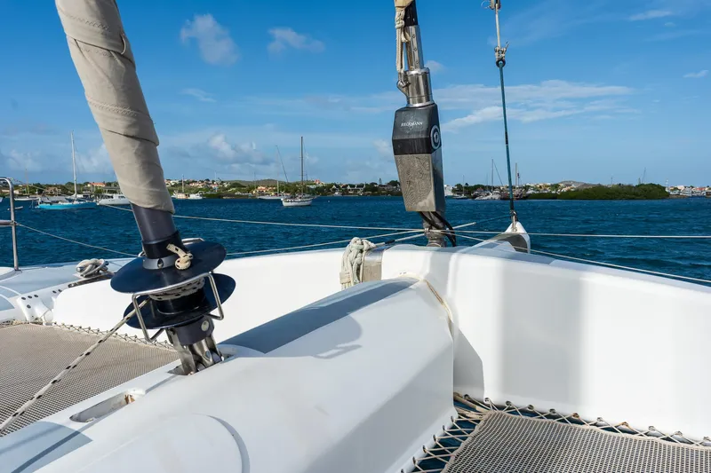 Orion Yacht Photos Pics Catana 90 catamaran sailing on blue waters, 2008 model, with clear skies and distant shoreline.