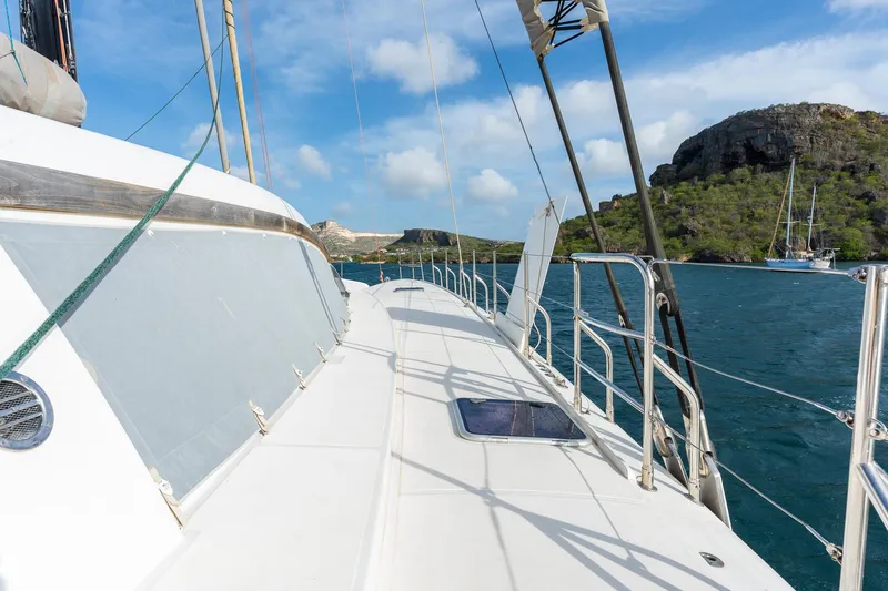 Orion Yacht Photos Pics Catana 90 yacht sailing near rocky coastline under blue sky, 2008 model.