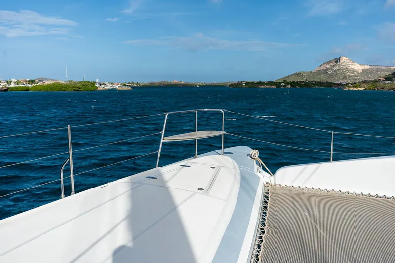 Orion Yacht Photos Pics Catana 90 catamaran sailing on blue waters with scenic coastal view, 2008 model.