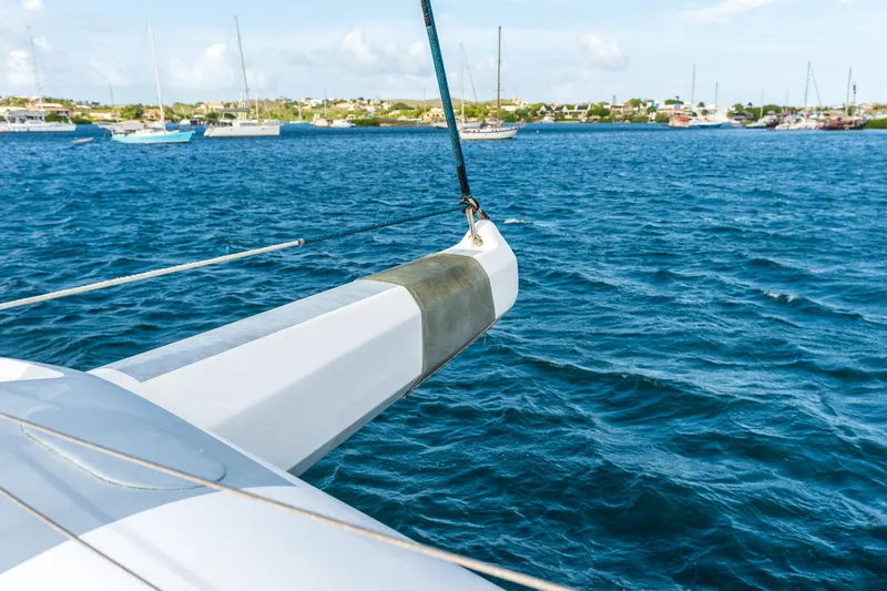 Orion Yacht Photos Pics Catana 90 catamaran sailing in blue waters near a coastal town, 2008 model.
