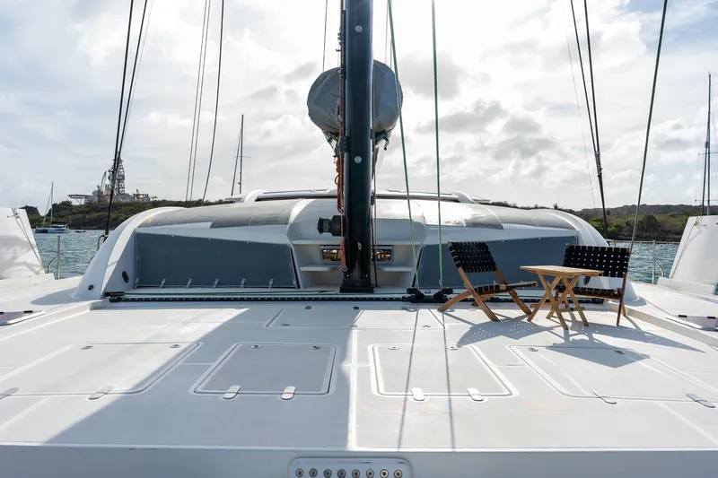 Orion Yacht Photos Pics Catana 90 catamaran deck with chairs, 2008 model, moored in a scenic harbor.