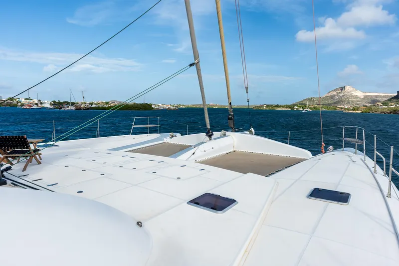 Orion Yacht Photos Pics Catana 90 catamaran deck, 2008 model, sailing on a sunny day with scenic coastal view.