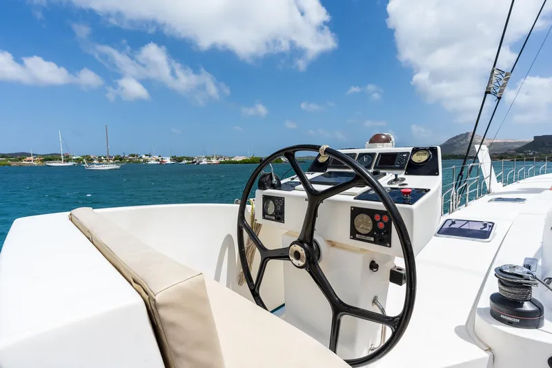 Orion Yacht Photos Pics Steering wheel of 2008 Catana 90 yacht with ocean view and clear skies.