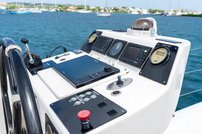 Orion Yacht Photos Pics Helm of 2008 Catana 90 yacht with navigation instruments, docked in a marina.