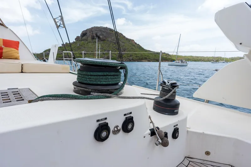 Orion Yacht Photos Pics Catana 90 yacht deck with winches, anchored near a scenic island, 2008 model.