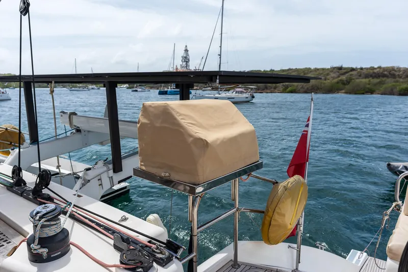 Orion Yacht Photos Pics Catana 90 yacht, 2008 model, docked with covered equipment and visible flag.