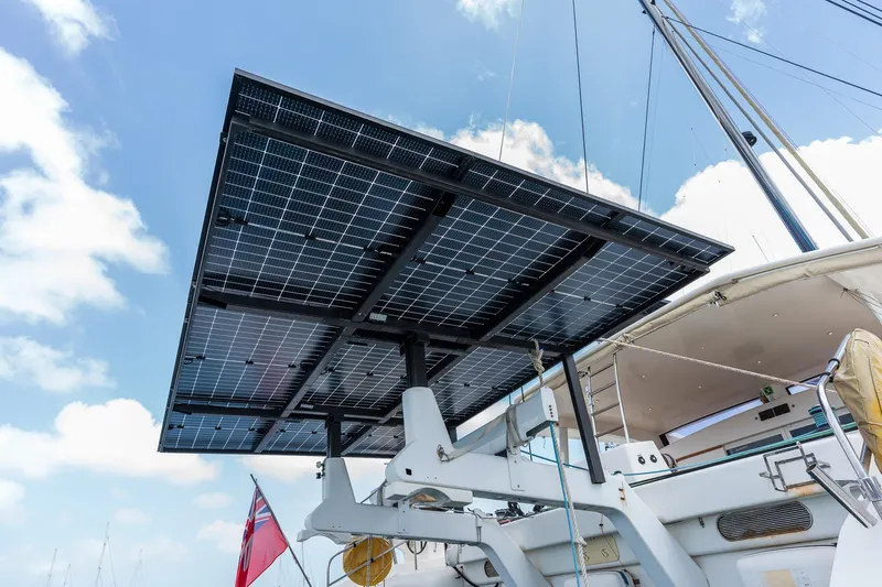 Orion Yacht Photos Pics Solar panels on a 2008 Catana 90 yacht under a clear blue sky.